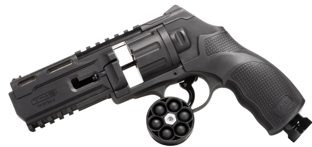A black tactical revolver-style airsoft gun with a detachable magazine and a separate circular 6-shot drum, shown on a plain white background.