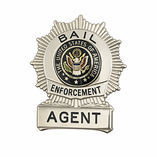 A silver-toned metal badge or pin with a sunburst border, a central circular seal reading 'The United States of America,' and the words 'BAIL ENFORCEMENT' and 'AGENT' on a plain white background.